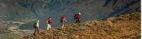 Trekkers on Buchanan peak with Mount Aspiring behind, walking above Matukituki valley, near Lake Wanaka |  <i>Colin Monteath</i>